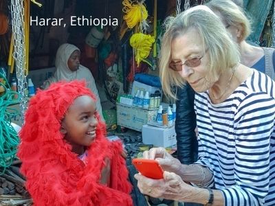 Little girl at Harar, East Ethiopia surprised to see photo of herself on tripper's mobile phone